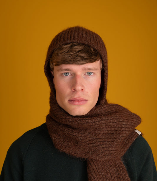Model wearing the chocolate brown Bisa Hooded Scarf with the hood up and scarf around the neck