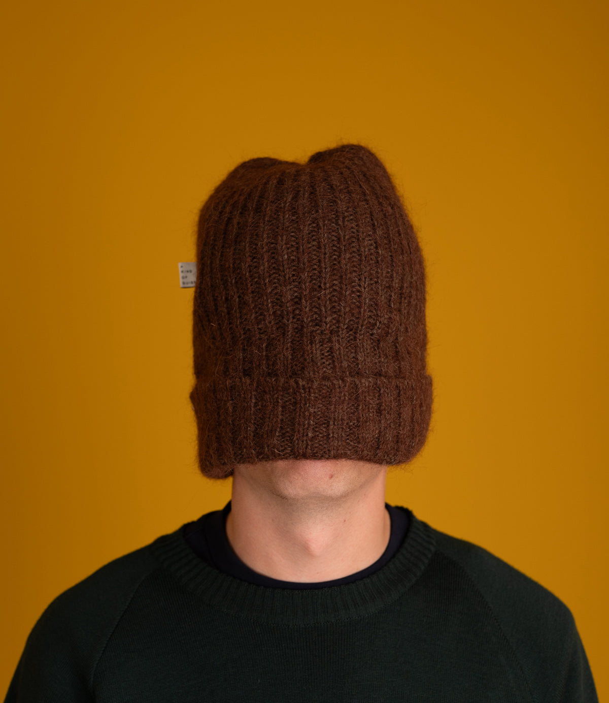 Model wearing the chocolate brown Orlu Beanie pulled down over the face