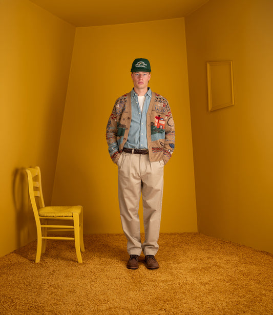Model wearing the Polo Ralph Lauren khaki Whitman chinos with a scenic cardigan and denim shirt